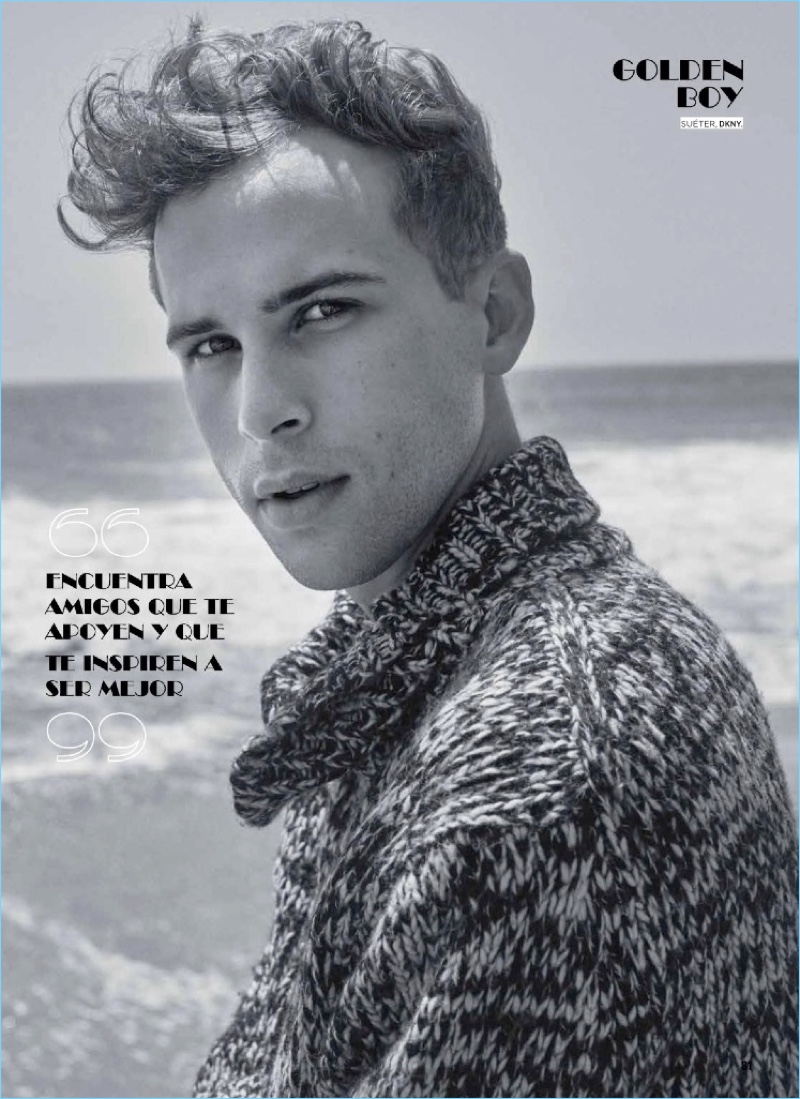 Taking to the beach, Tommy Dorfman wears a DKNY sweater.