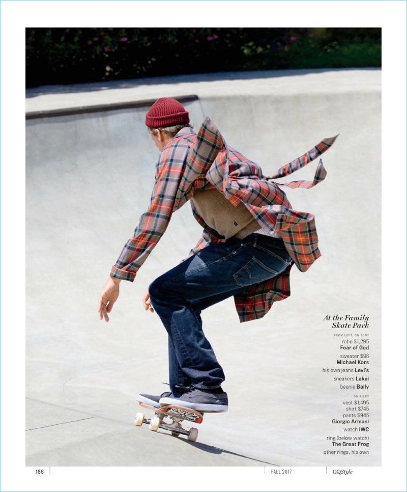 Skateboarding, Tony Hawk wears a Fear of God coat with a Michael Kors sweater. The skateboarding legend also dons his own Levi's jeans, Lakai sneakers, and a Bally beanie.