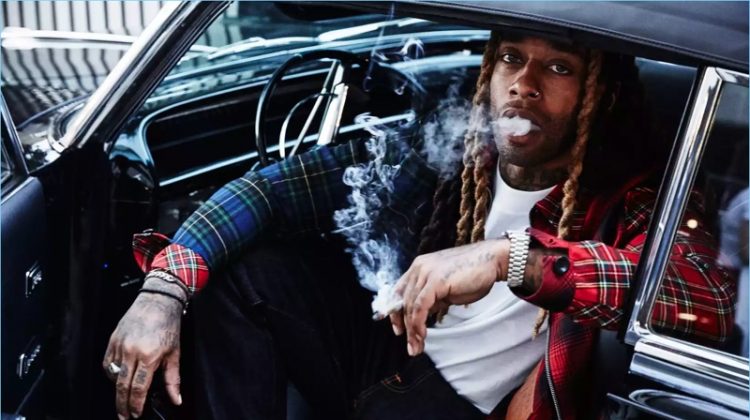 Getting behind the wheel, Ty Dolla $ign wears a Loewe jacket and NUDIE JEANS jeans.