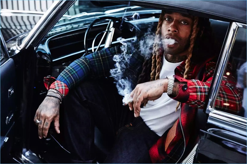 Getting behind the wheel, Ty Dolla $ign wears a Loewe jacket and NUDIE JEANS jeans.