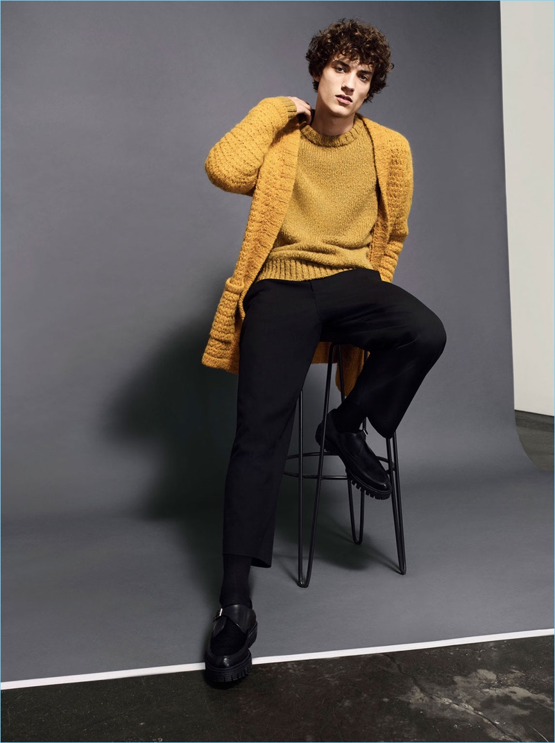 Embracing a pop of color, Serge Rigvava layers mustard yellow knitwear by Zara Man.