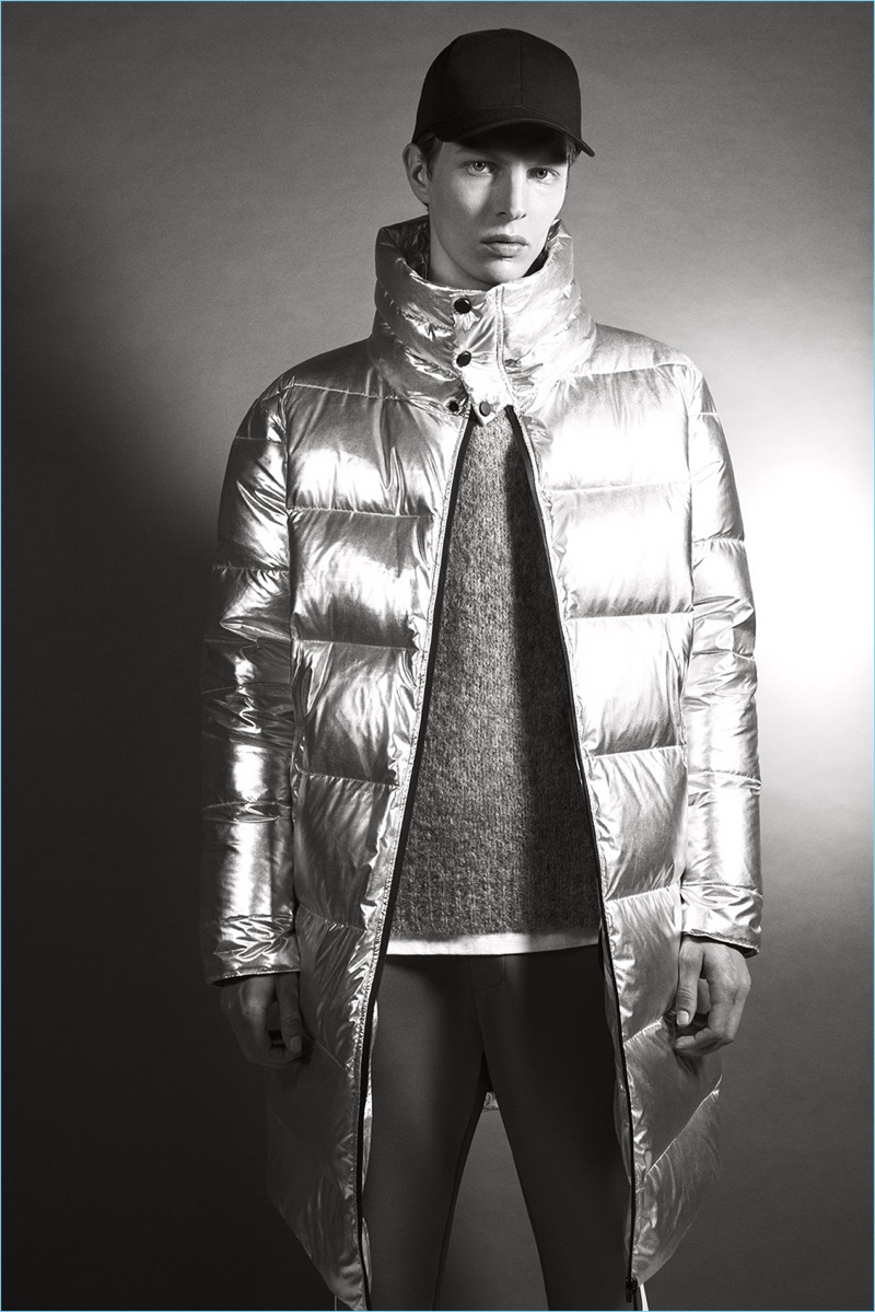 German model Tim Schuhmacher makes a statement in a metallic silver puffer jacket from Zara.