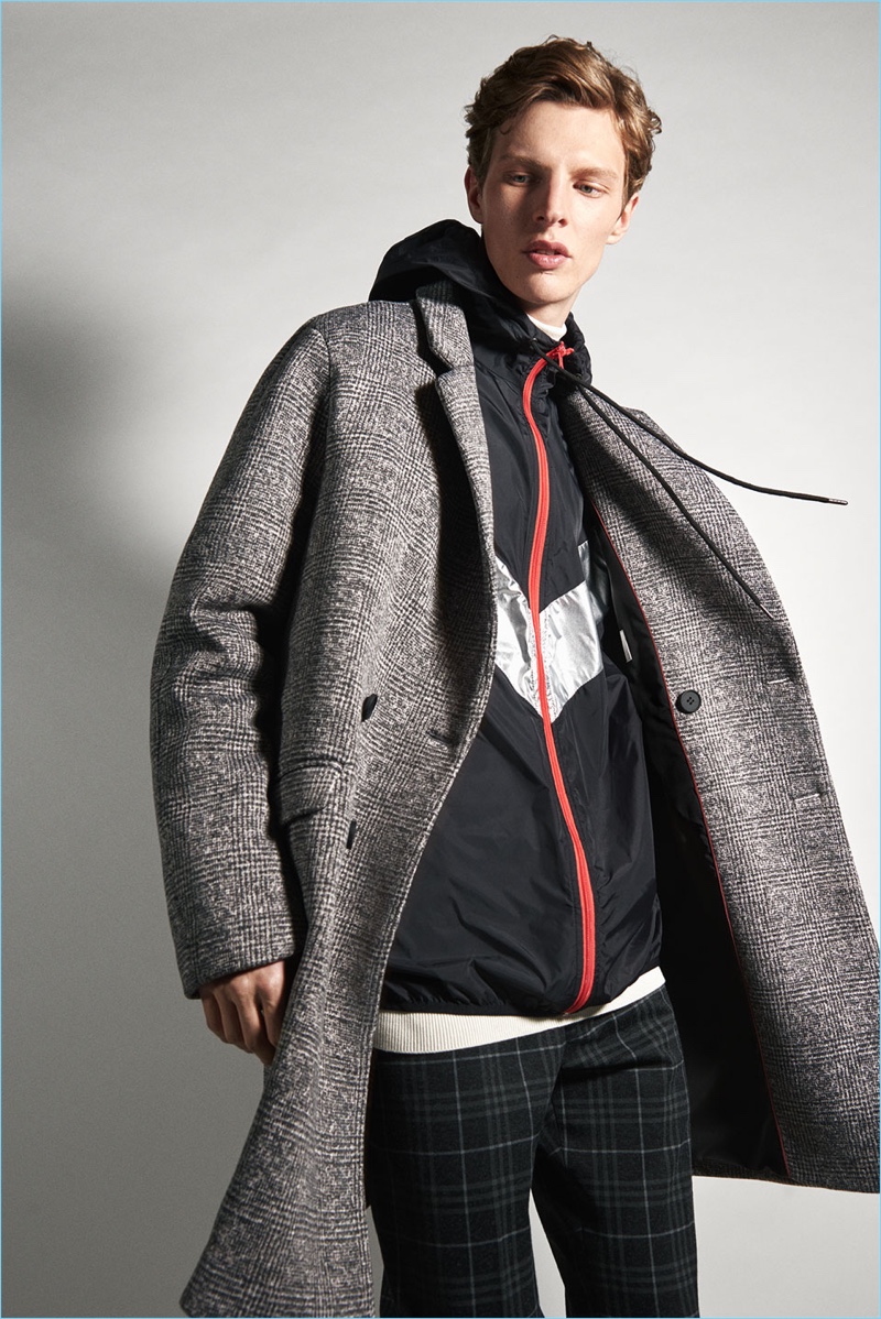 Connecting with Zara, Tim Schuhmacher layers a sporty jacket with a sharp coat.