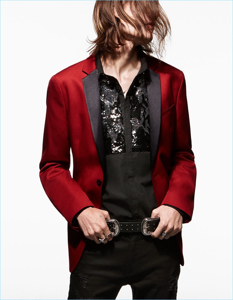 Marcel Castenmiller wears a red tuxedo jacket, embellished shirt, and skinny jeans by Zara Man.