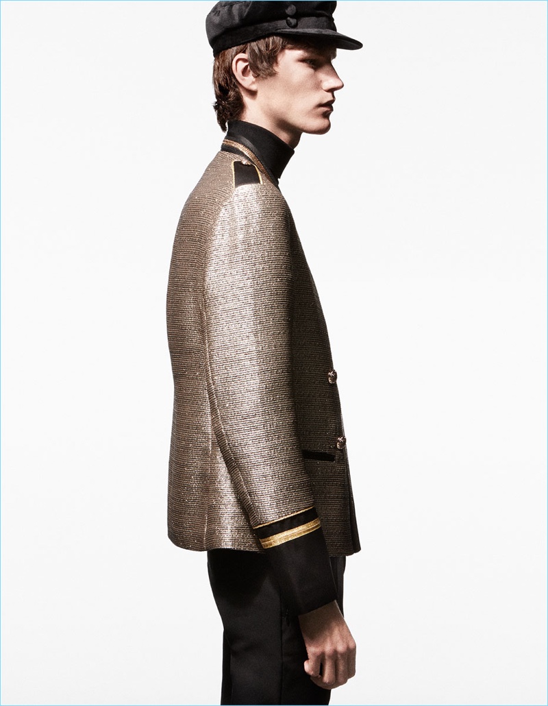 Delivering a side profile, Elias de Poot wears a gold military-style jacket by Zara Man.