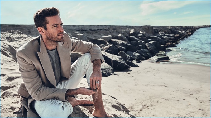 Armie Hammer wears a Calvin Klein double-breasted coat with a Schiesser sweatshirt. The American actor also sports Acne Studios jeans and an Alice Made This silver ring.
