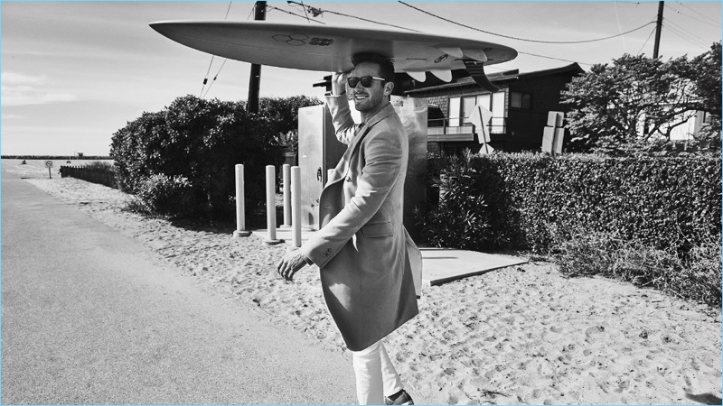 Taking to the beach, Armie Hammer wears a Calvin Klein coat, Schiesser sweatshirt, and Acne Studios jeans.