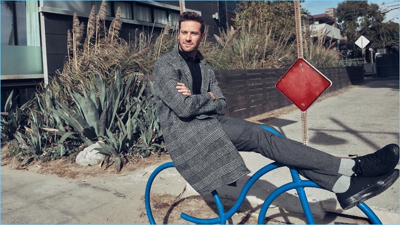 Connecting with Mr Porter, Armie Hammer wears a Solid Homme coat and Tom Ford polo shirt. He also sports NN07 trousers and Converse sneakers.