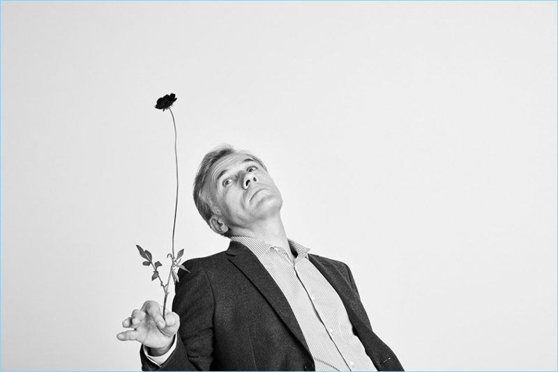 Appearing in a black and white photo, Christoph Waltz wears a Prada blazer and Joseph shirt.