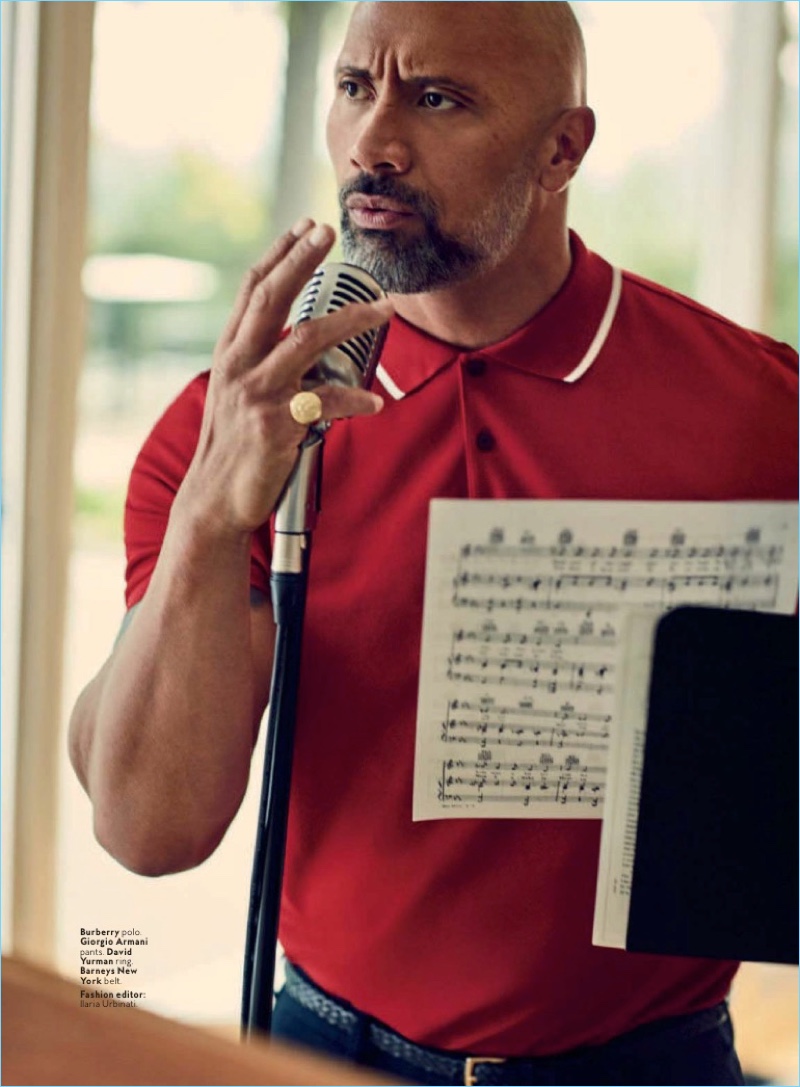Dwayne 'The Rock' Johnson wears a red Burberry polo with Giorgio Armani trousers. He also sports a Barneys New York belt and David Yurman ring. 