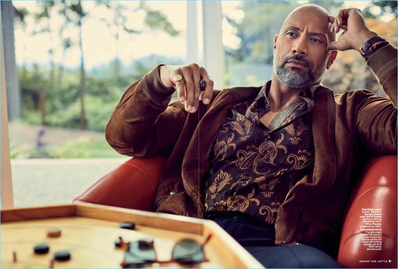 Starring in an InStyle shoot, Dwayne 'The Rock' Johnson dons a POLO Ralph Lauren suede bomber jacket. Johnson also rocks an Etro shirt with Giorgio Armani pants.