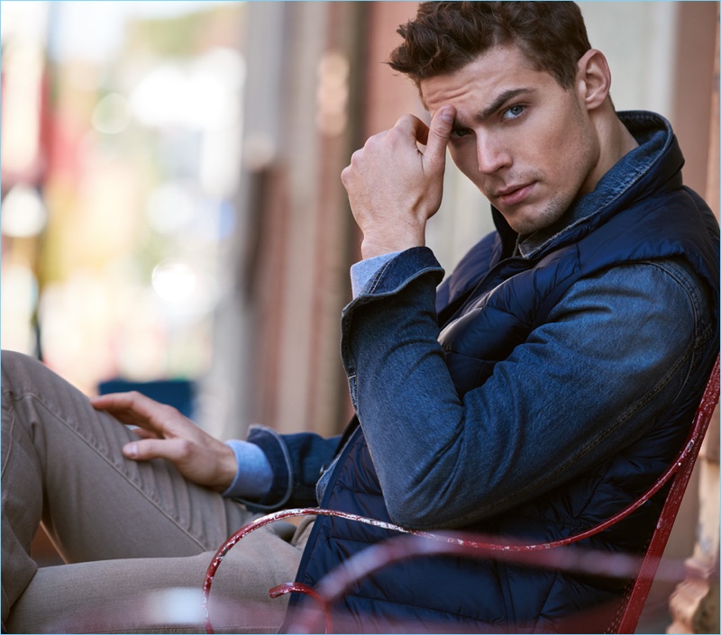 Model Jacob Hankin wears a Sunspel sweatshirt, AG jacket, and an Arc'Teryx Cerium vest. The Australian model also sports 7 For All Mankind jeans.