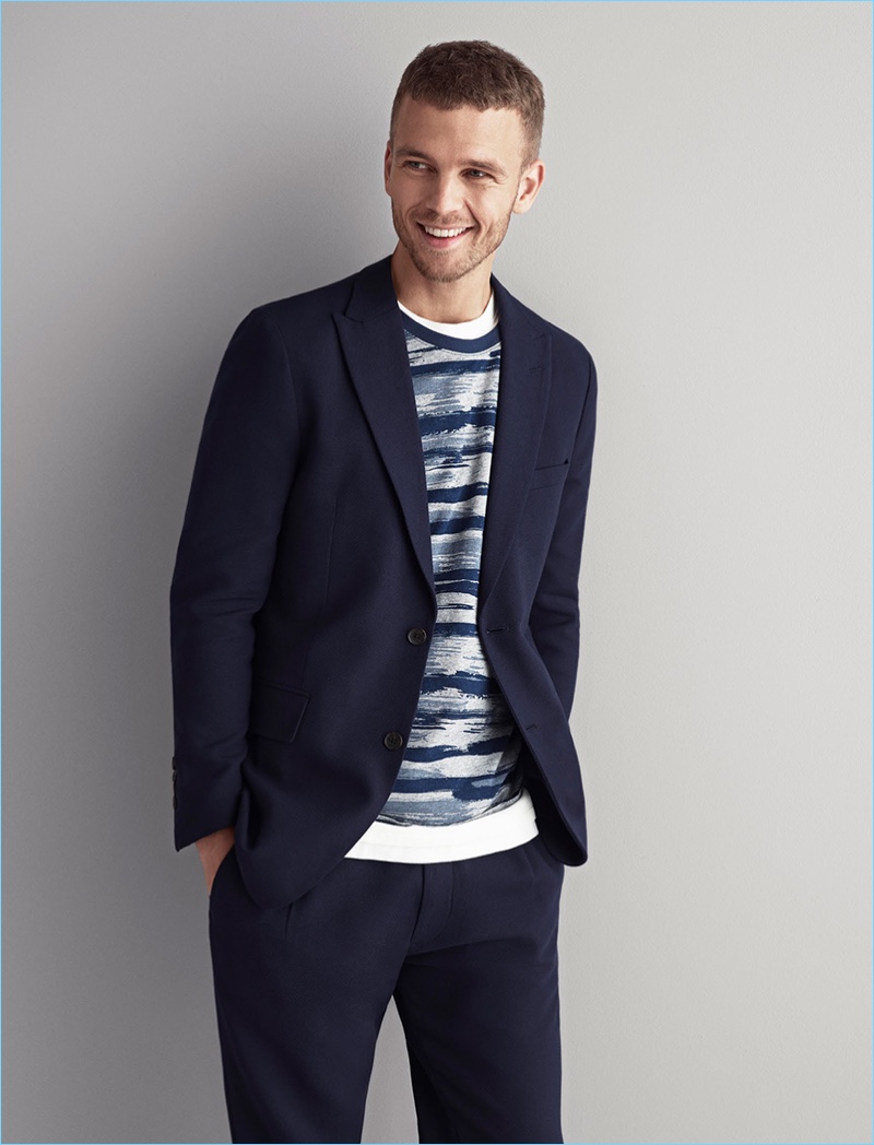 All smiles, Benjamin Eidem dons a sport coat from Esprit.