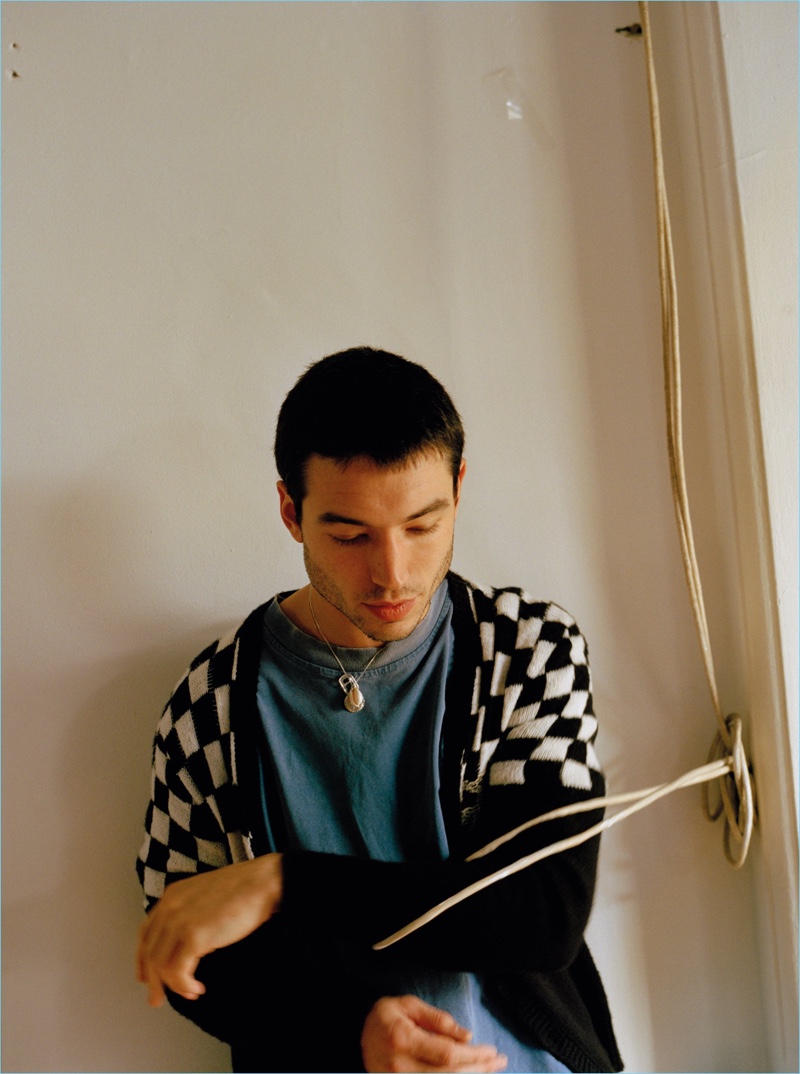 Front and center, Ezra Miller sports a Saint Laurent cardigan.