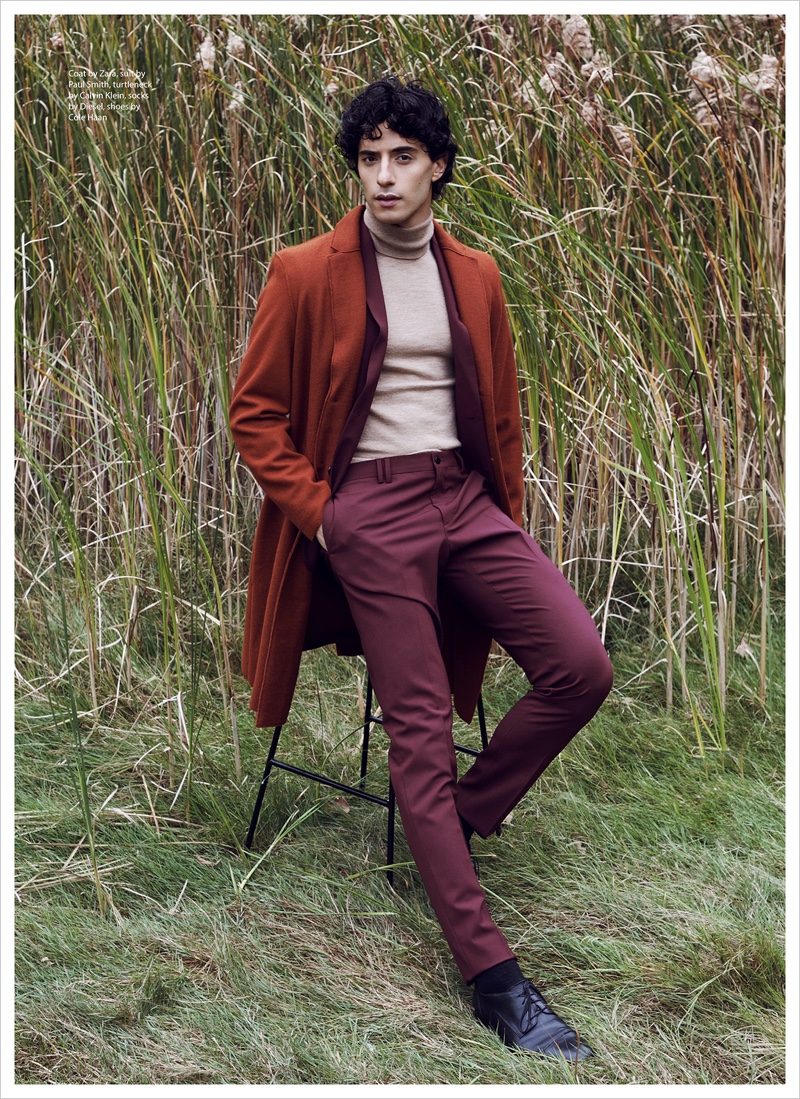 Reza wears coat Zara, suit Paul Smith, turtleneck Calvin Klein, socks Diesel, and shoes Cole Haan.