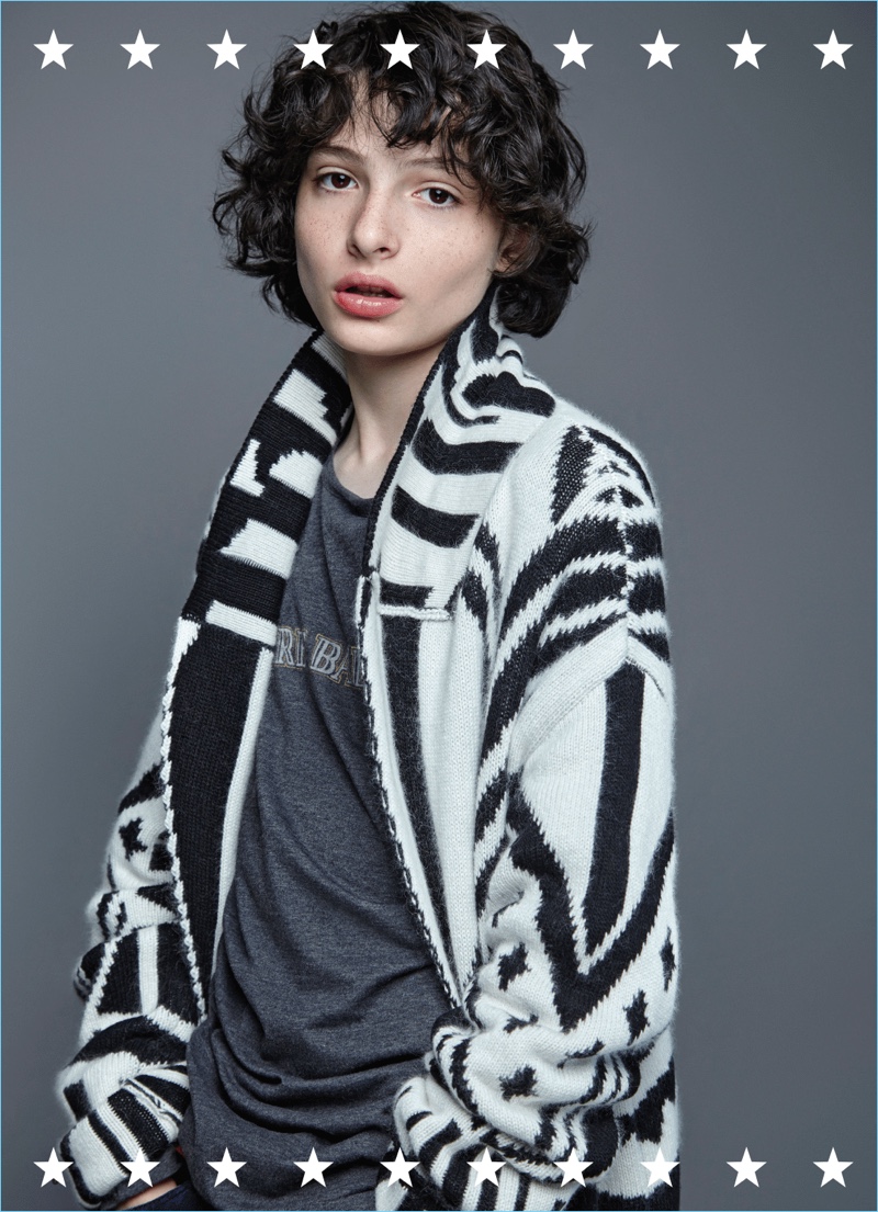 Starring in a photo shoot, Finn Wolfhard sports a Just Cavalli sweater with a Pierre Balmain t-shirt.