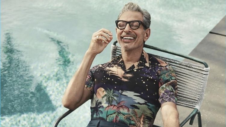 Relaxing poolside, Jeff Goldblum wears a Paul Smith shirt with Prada pants, a Josephs Shoes footwear.