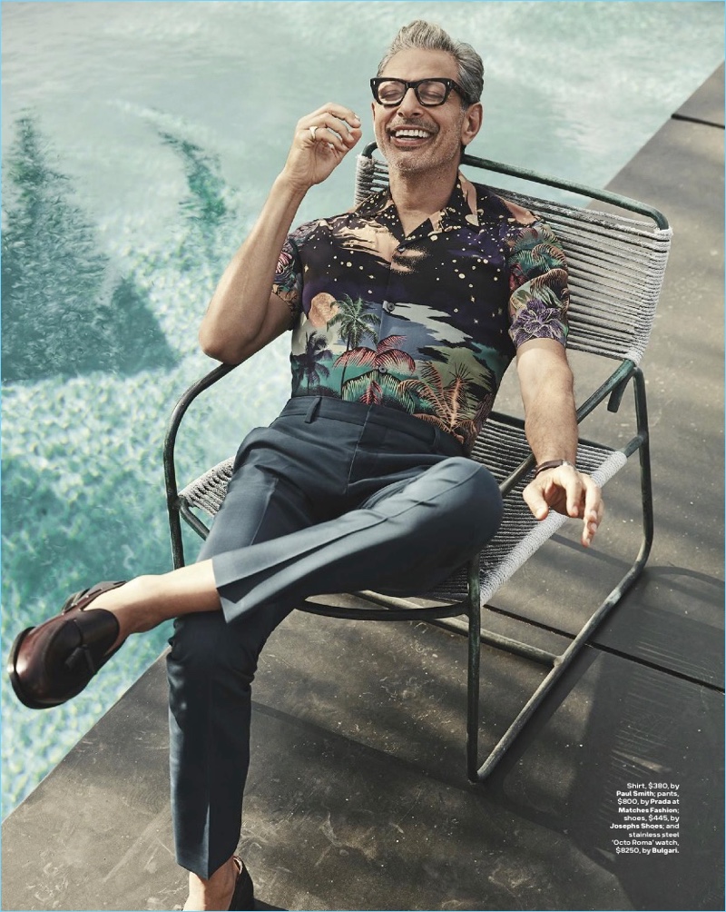 Relaxing poolside, Jeff Goldblum wears a Paul Smith shirt with Prada pants, a Josephs Shoes footwear.