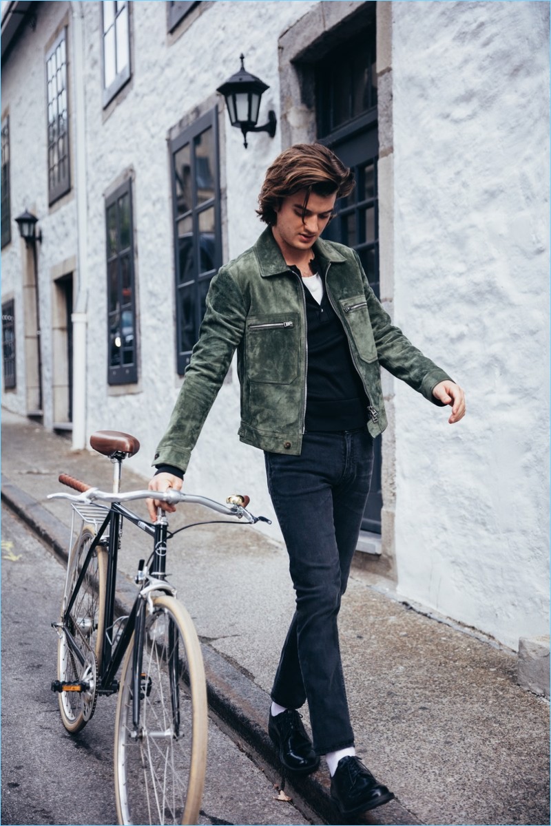 Actor Joe Keery wears a Tom Ford sweater and suede jacket with Acne Studios jeans. Keery also rocks J.Crew dress shoes.