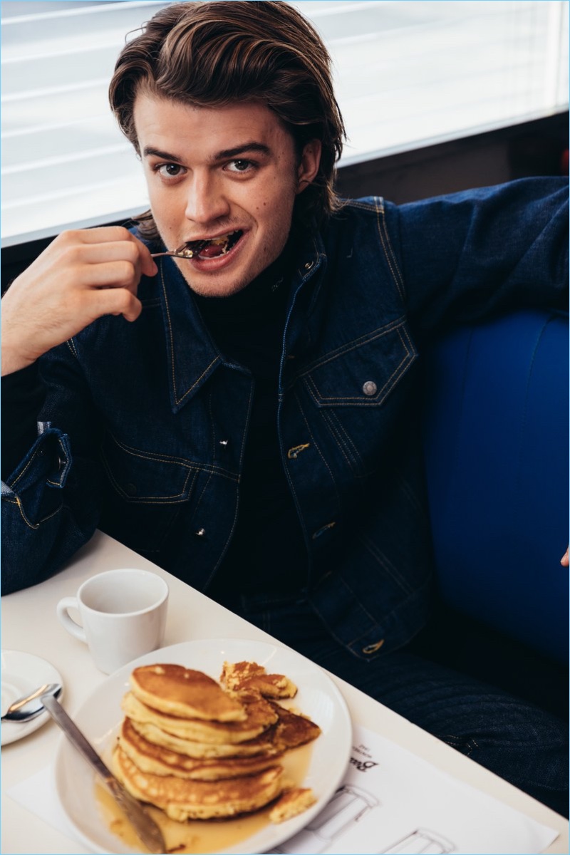 Enjoying breakfast at Beautys Luncheonette, Joe Keery wears a Calvin Klein turtleneck and denim jacket.