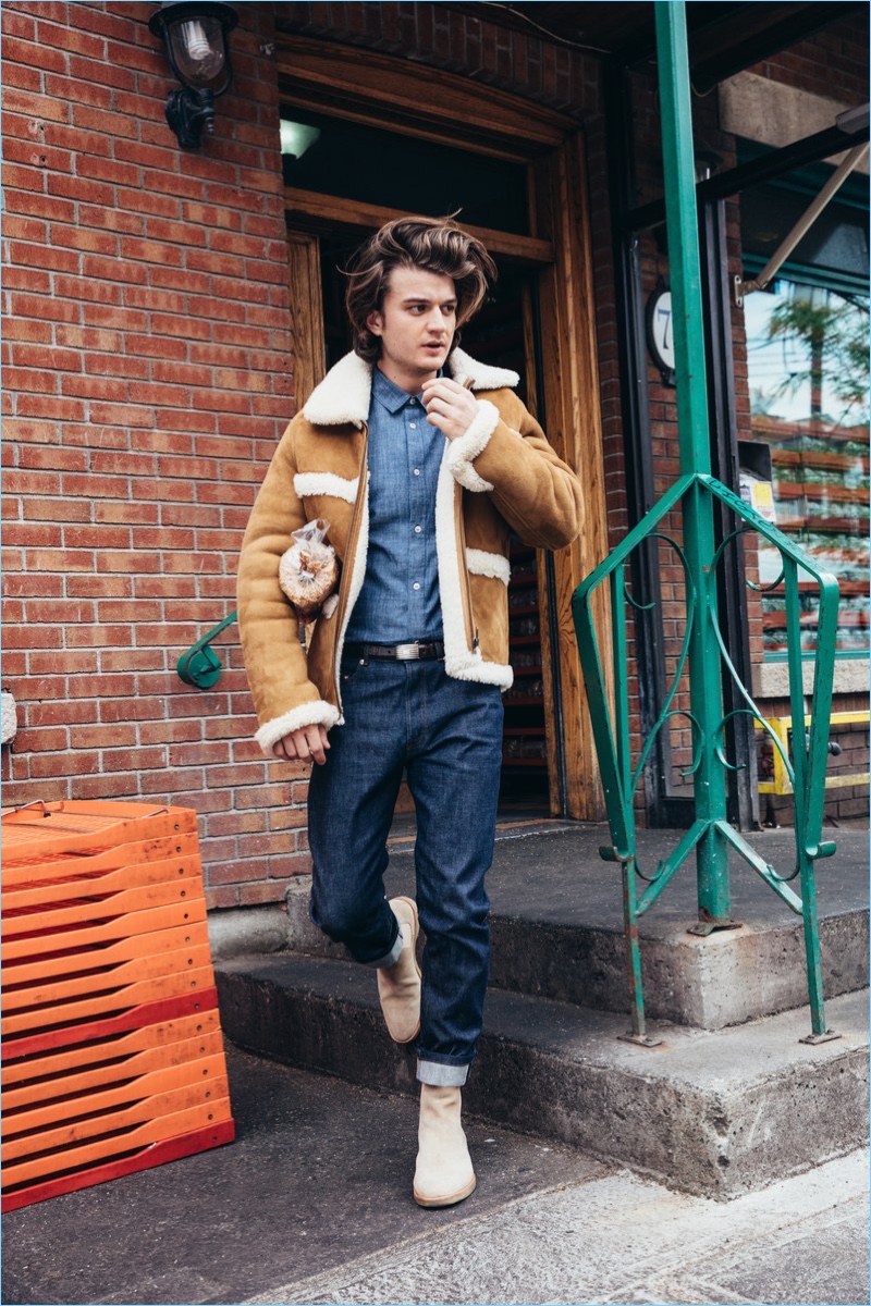 Stepping out, Joe Keery wears an A.P.C. x Louis W. shearling jacket. The Stranger Things actor also dons an A.P.C. denim shirt and jeans. New Republic by Mark McNairy boots and a J.Crew belt complete his look.