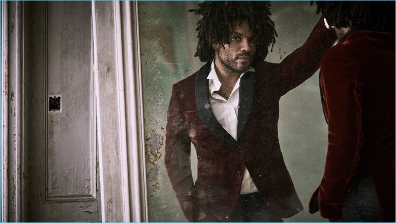 Lenny Kravitz sports a red Berluti velvet tuxedo jacket, Caruso shirt, and Balmain biker jeans.