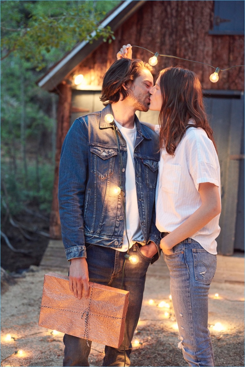 Sharing a kiss, Jeremy Young and Sara Blomqvist wear Levi's.