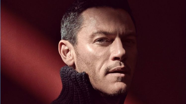 Actor Luke Evans wears a knit by Hugo Boss.