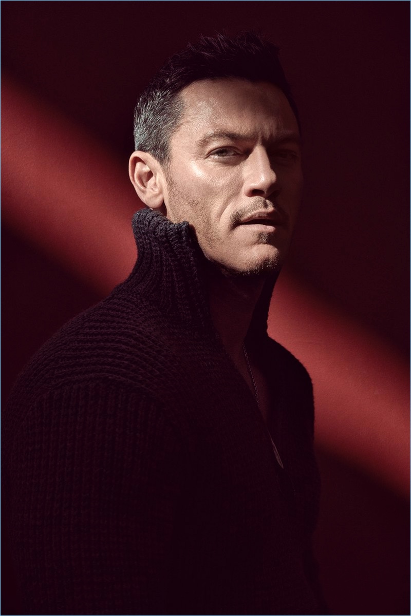 Actor Luke Evans wears a knit by Hugo Boss.