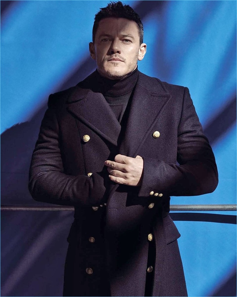 Donning a double-breasted coat, Luke Evans graces the pages of GQ Portugal.