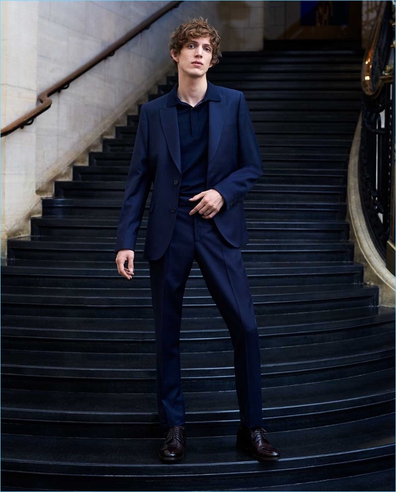 Making a case for blue, Xavier Buestel wears a Paul Smith suit, polo, and leather derby shoes.