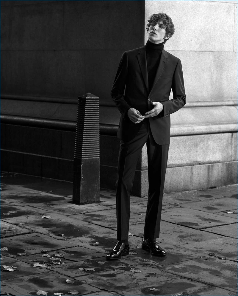 Donning a Saint Laurent turtleneck, Xavier Buestel also wears a Lanvin suit and Tod's derby shoes.