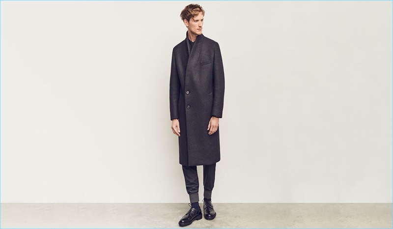 Front and center, Bastiaan Ninaber wears a double-breasted coat and track pants by Wooyoungmi. The top model also sports a Lemaire shirt and Lanvin derby shoes.