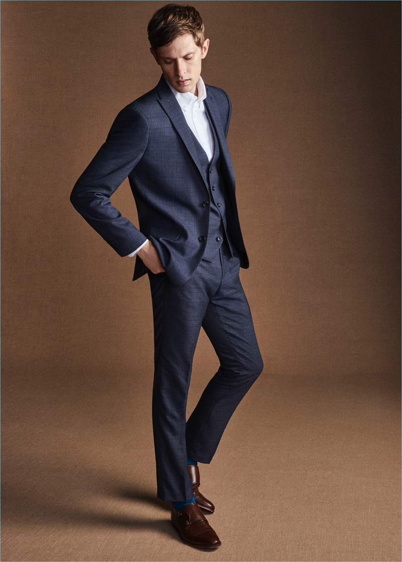 Mathias Lauridsen dons a sharp navy suit for Next.