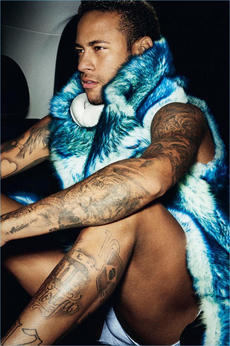 Soccer star Neymar Jr. wears a sleeveless fur coat from Dior Homme.