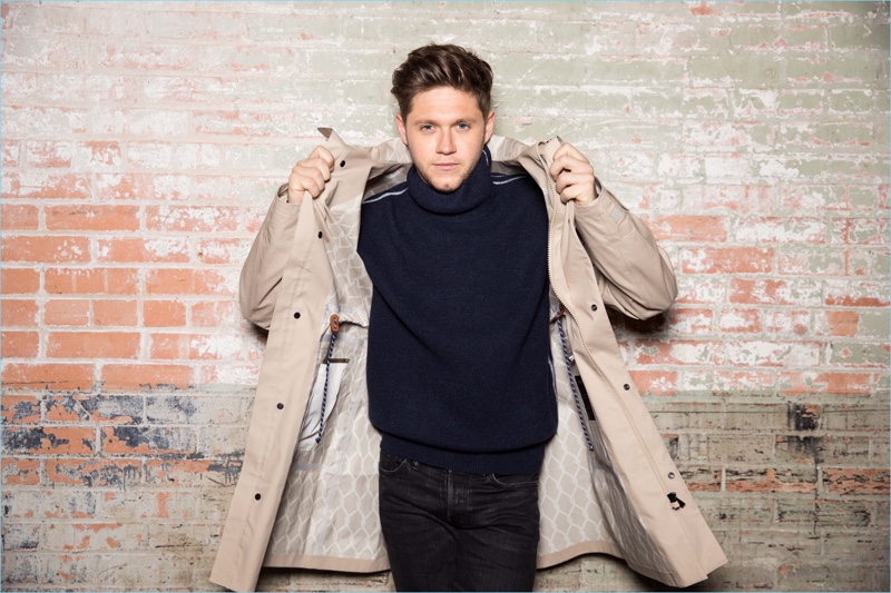 Niall Horan wears a Z Zegna coat with a Bottega Veneta sweater. He also wears Tom Ford jeans.