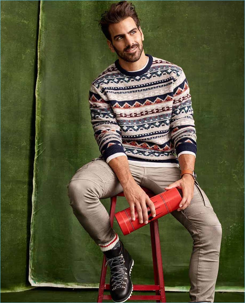 Embracing the holiday season, Nyle DiMarco wears a LE 31 lambswool alpine jacquard sweater with cargo moto jeans and Fracap x Simons boots.