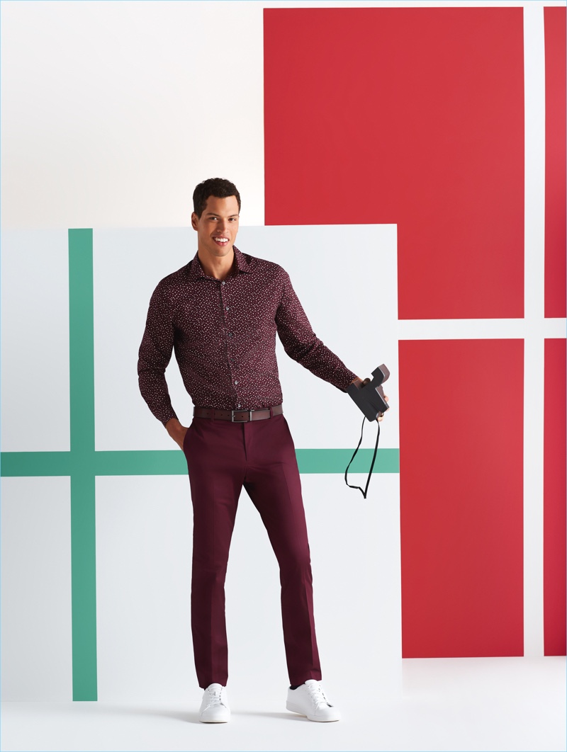 Family Holiday Photo: Model Chris Moore wears a Perry Ellis print shirt, suit pants, and white sneakers.