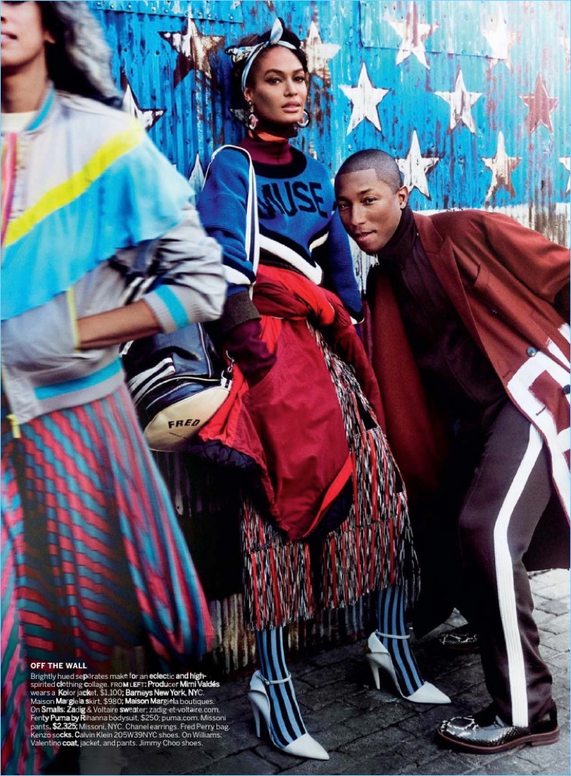 Joan Smalls and Pharrell pose for an image together. Pharrell wears a Valentino look with Jimmy Choo shoes.