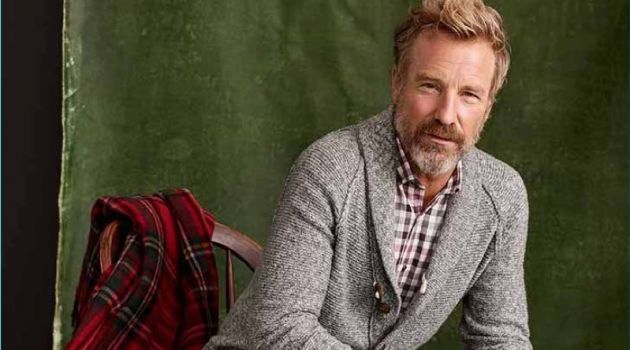 Connecting with Simons, Rainer Andreesen wears a smart cardigan and jeans.