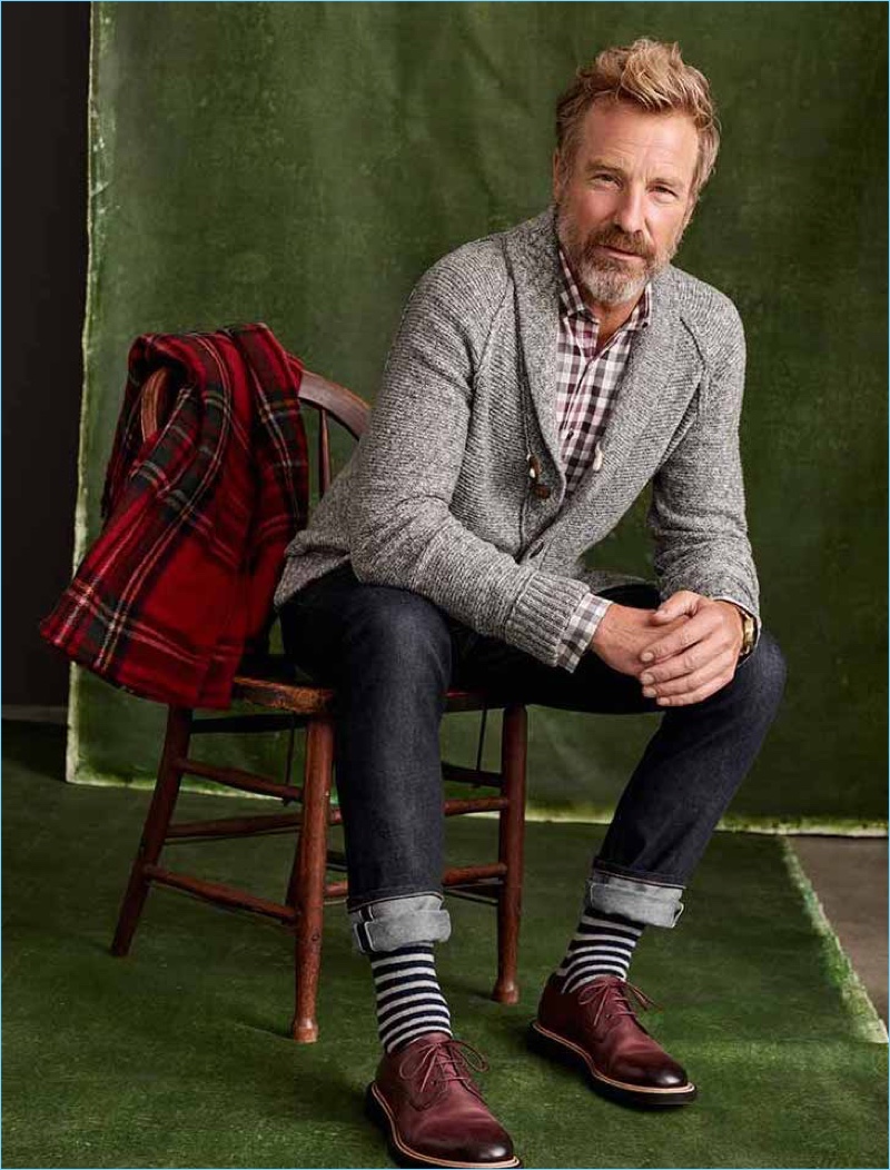 Connecting with Simons, Rainer Andreesen wears a smart cardigan and jeans.
