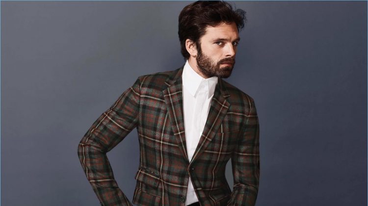 Standing out in checks, Sebastian Stan wears a plaid jacket and crisp dress shirt by Gucci.