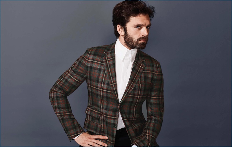 Standing out in checks, Sebastian Stan wears a plaid jacket and crisp dress shirt by Gucci.