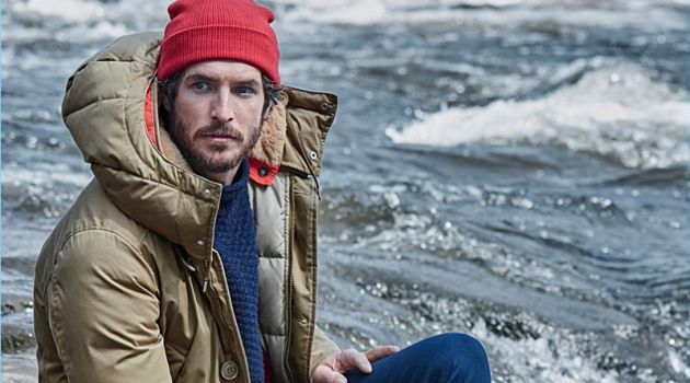 The Coat Portfolio: Justice Joslin Prepares for Winter with Simons Reuniting with Simons, Justice Joslin wears a Holubar parka and Sorel boots. A red LE 31 knit beanie, navy sweater, and work socks bring Justice's outfit together.
