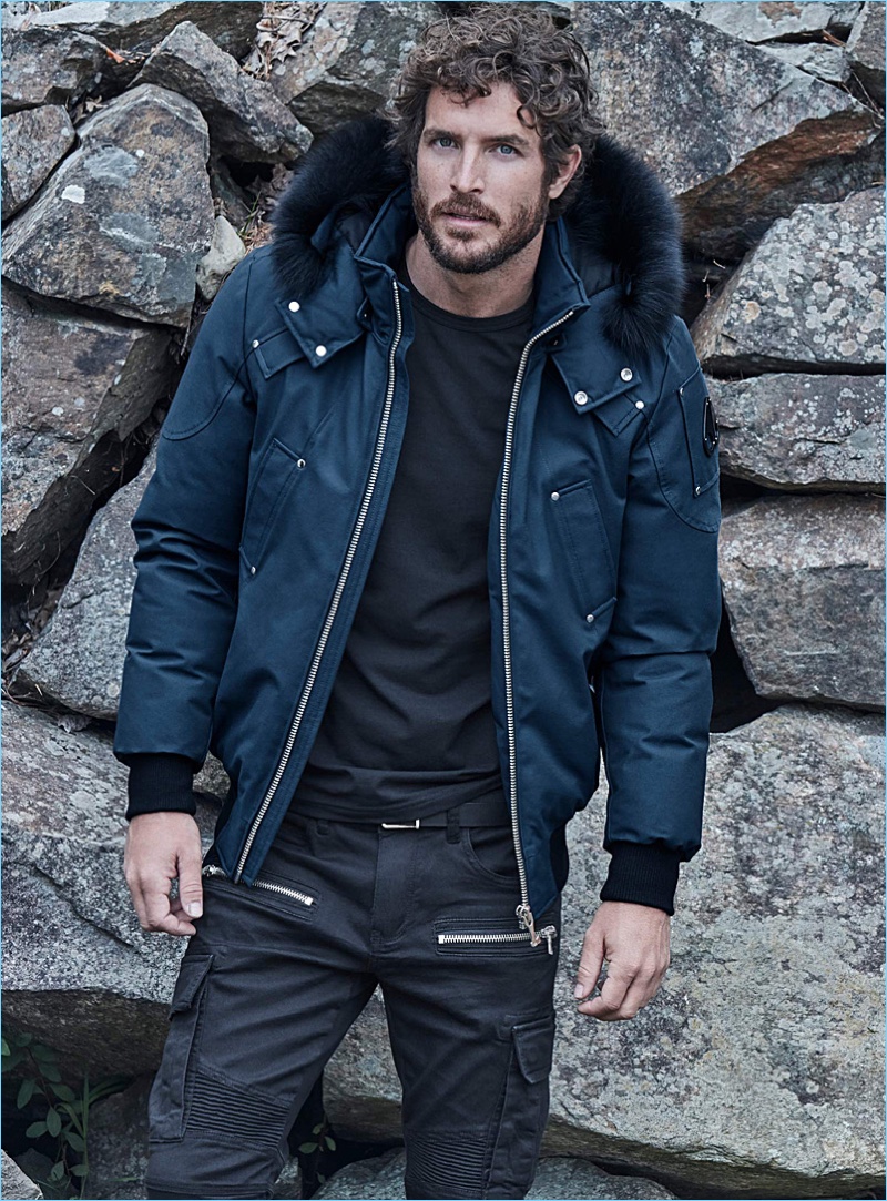 Model Justice Joslin wears a Moose Knuckles bomber jacket with a LE 31 t-shirt and cargo jeans.