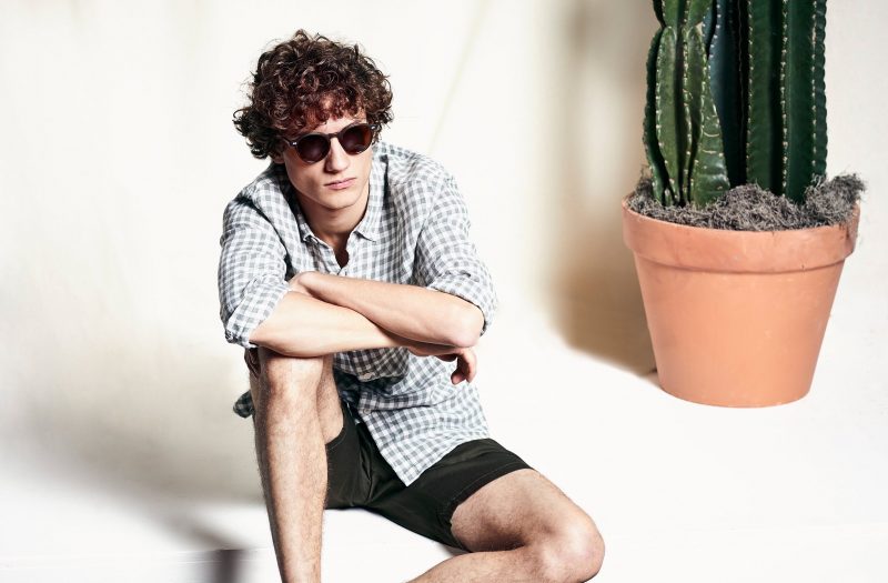 Ready for warm weather, Serge Rigvava wears. a Todd Snyder shirt and chino shorts. Serge also rocks MOSCOT x Todd Snyder sunglasses.