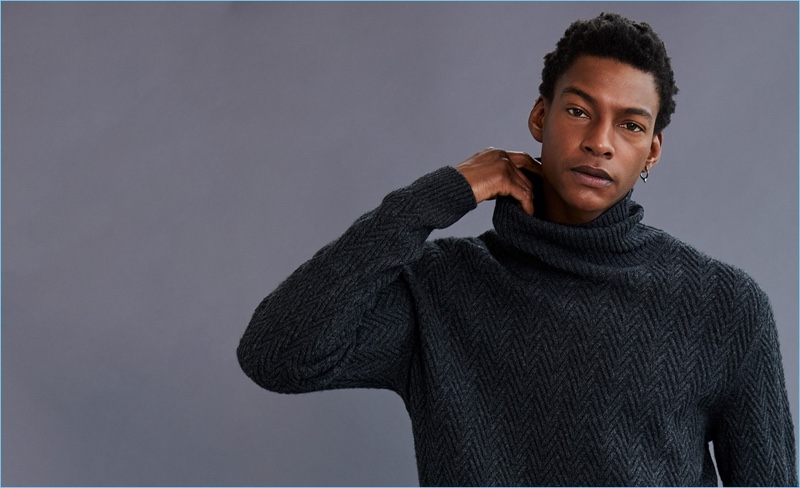 Ty Ogunkoya wears an Ermenegildo Zegna turtleneck sweater.