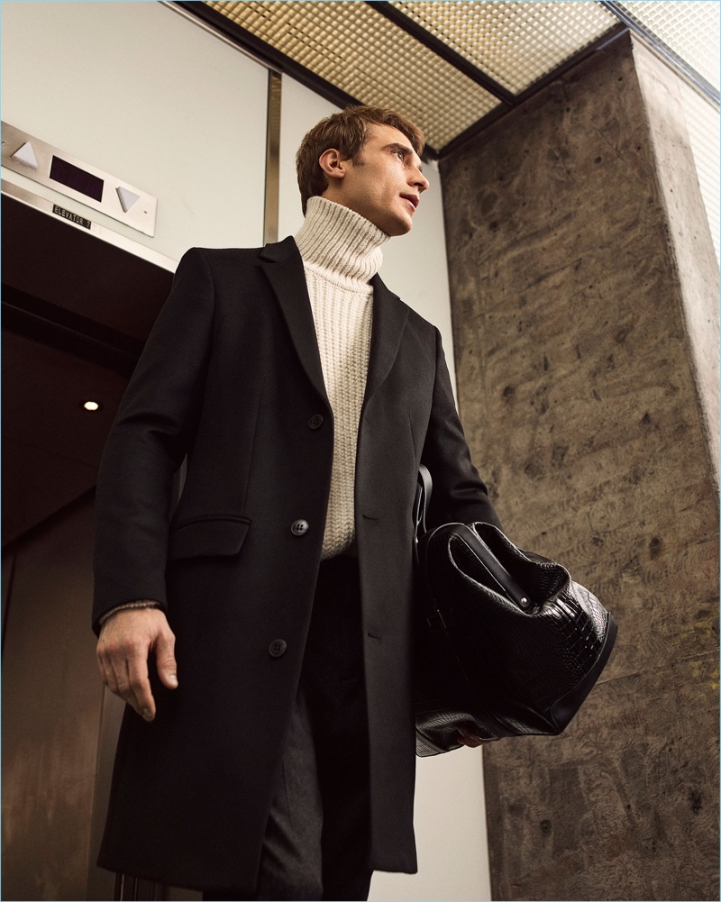 French model Clément Chabernaud dons a Zara Man overcoat and turtleneck sweater.