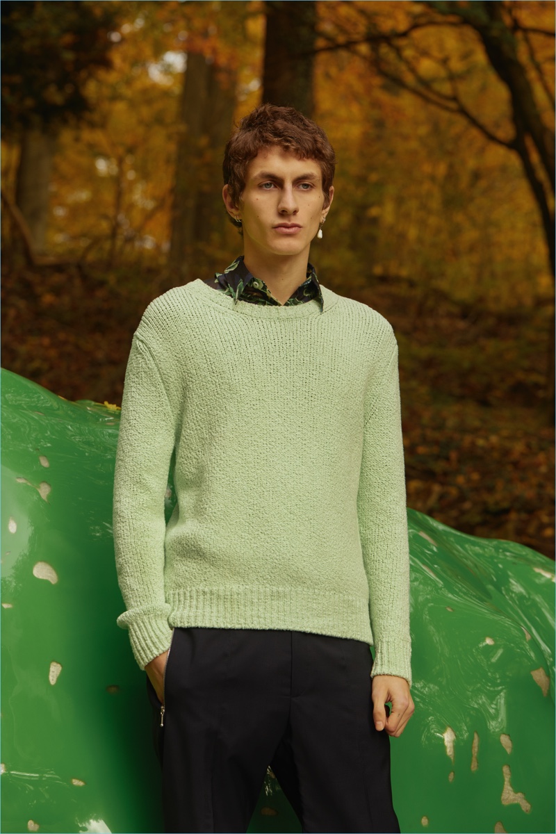 Front and center, Henry Kitcher wears a Stella McCartney sweater, shirt, and pants.