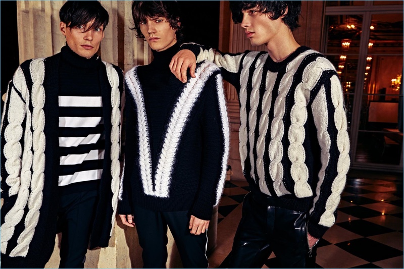 Models Victor Goujon, Elias de Poot, and Oussama Guessoum don knitwear from Balmain's pre-fall 2018 men's collection. » Balmain Goes Glam for Rock-Inspired Pre-Fall '18 Collection Models Victor Goujon, Elias de Poot, and Oussama Guessoum don knitwear from Balmain's pre-fall 2018 men's collection.